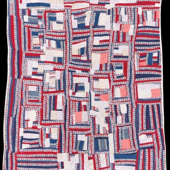 A close-up photo of a red, white & blue patchwork quilt on display at the Museum of Fine Arts. Caption: "“Votequilt” 1975, Irene Williams. Museum purchase with funds from the Frank B. Bemis Fund, the Heritage Fund for a Diverse Collection, and Gallery Instructor 50th Anniversary Fund to support The Heritage Fund for a Diverse Collection, and gift of Souls Grown Deep Foundation from the collection of Vanessa Vadim. © Estate of Irene Williams/Artists Rights Society (ARS), New York. PHOTO: MUSEUM OF FINE ART"