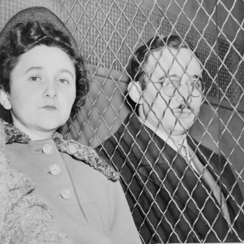 Ethel and Julius Rosenberg prison visit, separated by mesh wire fencing.