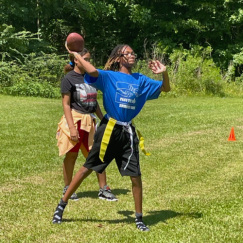 Camper tossing a football