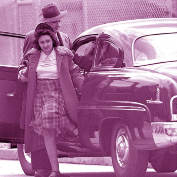 A black and white photo, tinted purple. Ethel Rosenberg steps out of a car facing the camera. Three men in suits, coats, & hats stand around the car and look to her. Ethel wears a mid-length plaid skirt, a white blouse, a coat, and a hat.