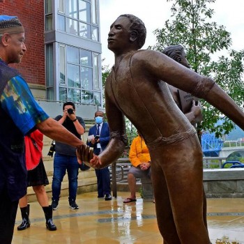 Sculptor Jerome Meadows shakes the hand of his figure of Ed Johnson during its dedication at a memorial at the south side of the Walnut Street Bridge in Chattanooga, Tenn., on Sunday, Sept. 19, 2021. The two other figures are those of Noah Parden and Styles Hutchens, two African-American attorneys from Chattanooga, who provided a courageous and successful defense for Johnson, who on March 19, 1906, was mob-lynched from the second span of the Walnut Street Bridge.