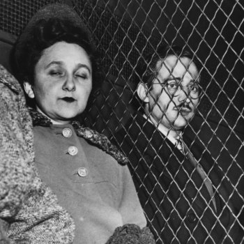 Ethel and Julius Rosenberg prison visit, separated by mesh wire fencing.