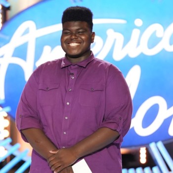 Douglas Mills Jr. stands for his audition in Austin, TX for American Idol against a brightly lit stage with the show's logo.Today's #StrangeFruitMOTD comes from Austin, TX where a Houston native high school student, Douglas Mills, Jr. auditioned for this season of American Idol with a powerful rendition of "Strange Fruit." The song, written by Abel Meeropol and made famous by Billie Holiday, protests lynchings of Black Americans and is a staple of the civil rights movement. The emotio (ABC/Eric McCandless)