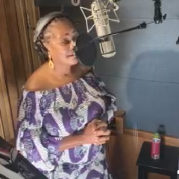 Tonya Pinkins performing "Strange Fruit, Revisited" in a recording studio behind the microphone