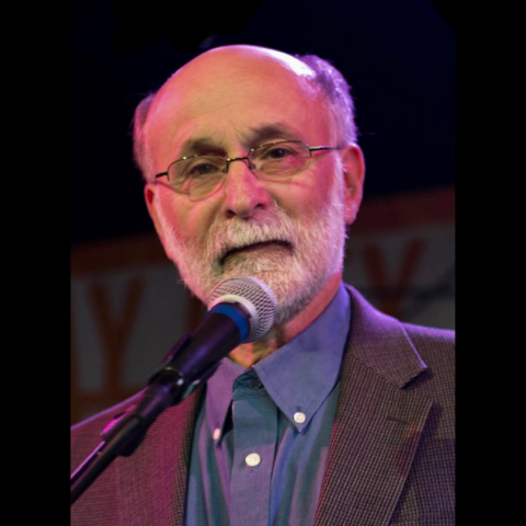 Close-up of Robert Meeropol behind microphone