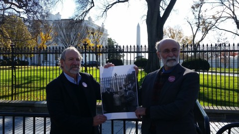 Rosenberg sons Robert & Michael Meeropol at the White House gates, holding a photo of themselves as children in 1953 at the same gates