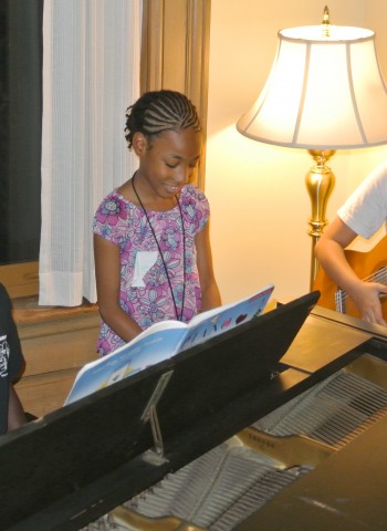 Three beneficiaries who have all received grants for music lessons give an impromptu performance at a Gathering